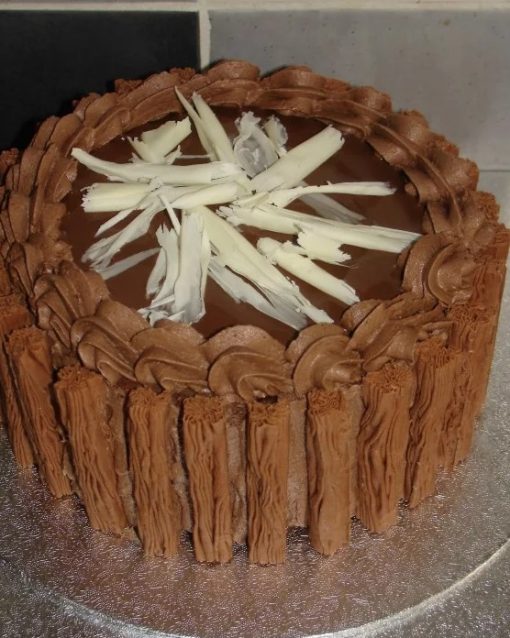Chocolate cake with flakes around the outside of it